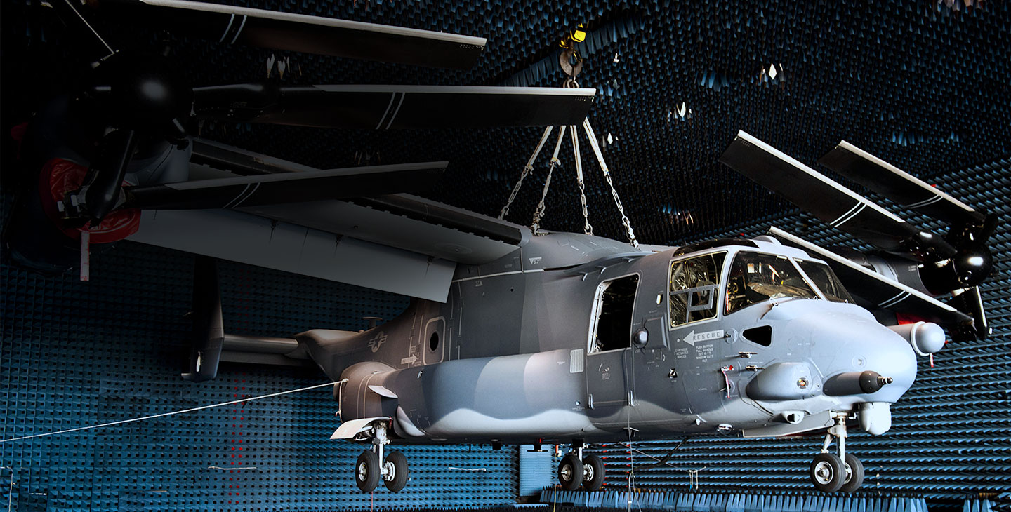 Gray helicopter hanging from the ceiling of an anechoic chamber