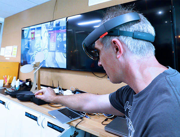 Viasat engineer tests out virtual equipment in a lab