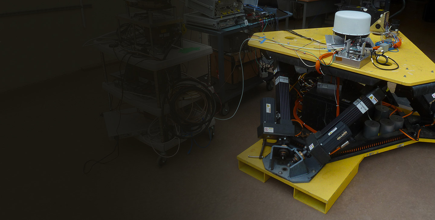 Antenna testing taking place inside a Viasat lab on an antenna component wtih yellow plates