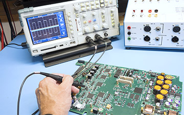 Close-up of a hand working on an application-specific integrated circuit (ASIC) for enhanced space technology