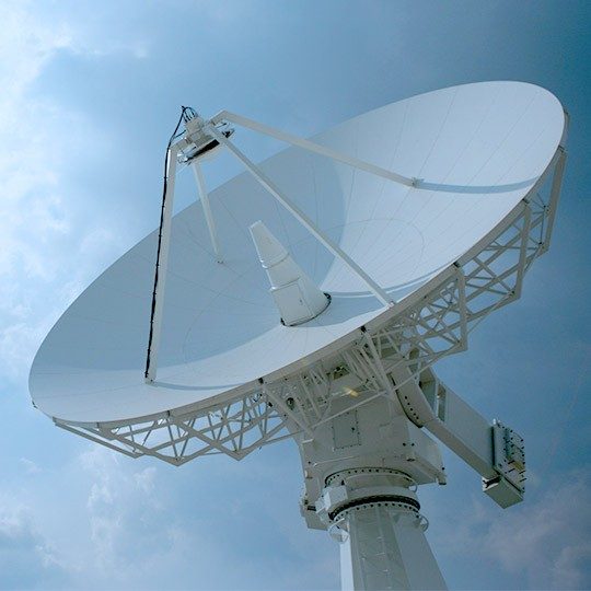 Close-up of a ground station antenna pointed at the sky