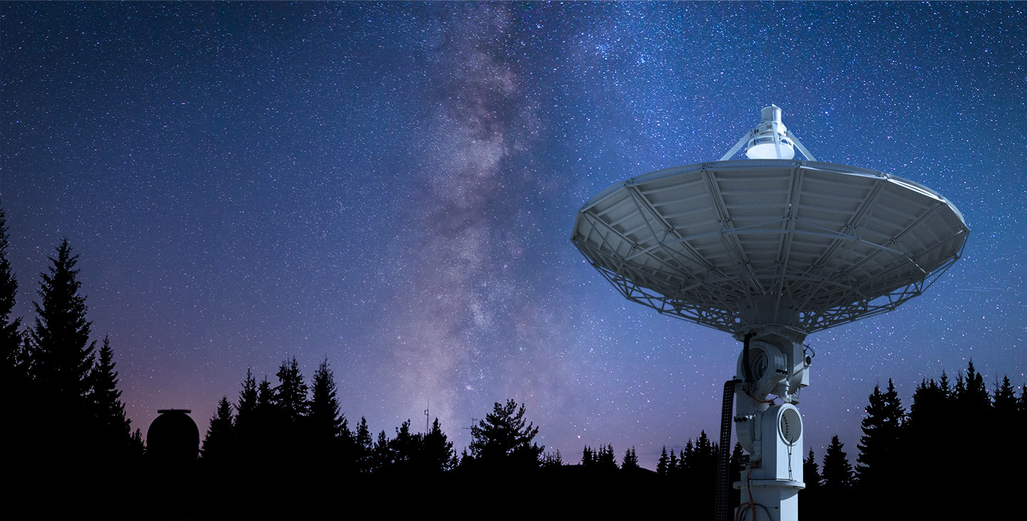 Viasat ground station pointed at the night sky against a backdrop of stars