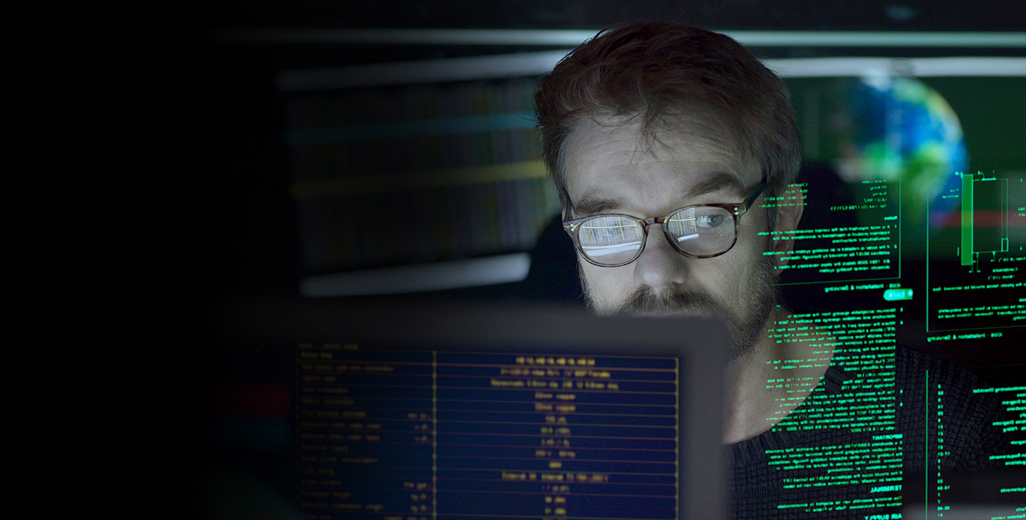 Man wearing glasses looking at projected computer data