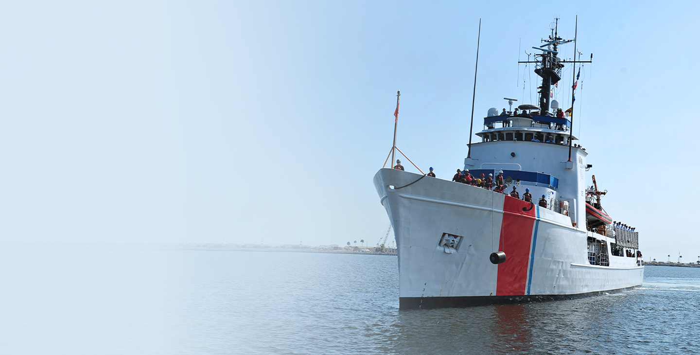 Large ship with maritime antennas and the crew standing on the bow