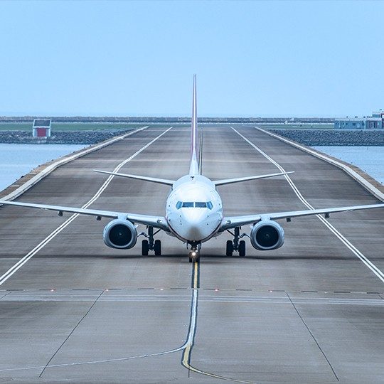 View of the front of a commercial airplane coming down the runway
