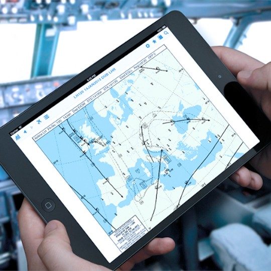 Close-up of hands holding a tablet reviewing flight operations software
