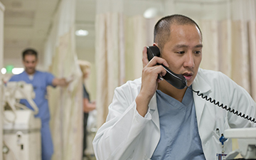a physician talking on the phone, connected by Viasat's reliable satellite-based connectivity solutions