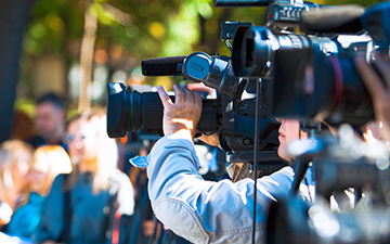 Camera crew filming and broadcasting with portable enterprise internet