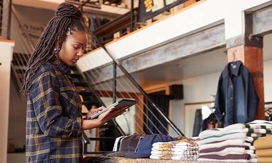 Female retail associate using Viasat satellite internet from tablet