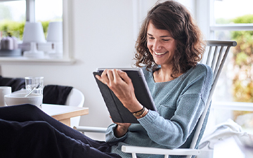 Woman on tablet enjoying Wi-Fi