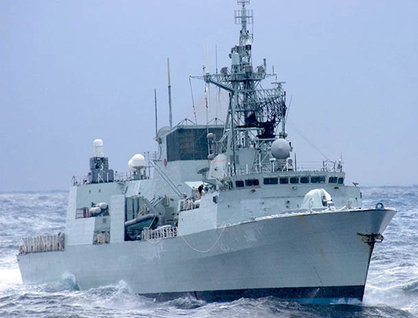 Military vessel at sea with visible SATCOM equipment