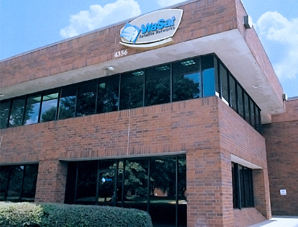 Side-angled view of a brick Viasat building in Atlanta, CA