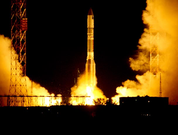 ViaSat-1 launching into the night sky from a launch pad