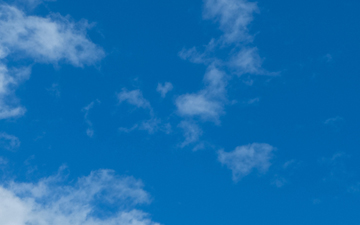 Light-blue sky background with white clouds