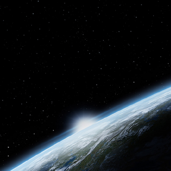 View from space of the edge of the Earth with the sun peeking over the horizon