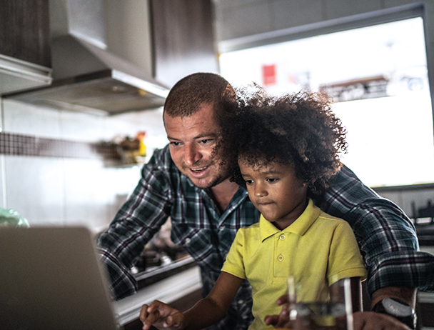 Man and child looking at computer