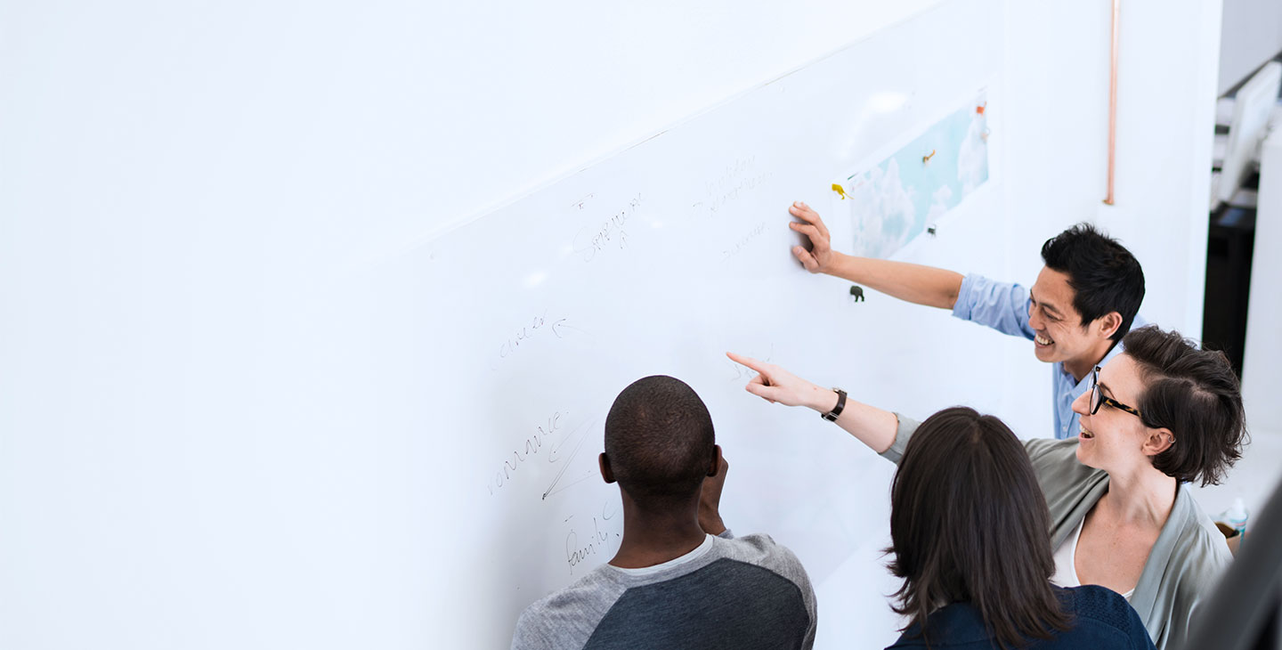 Viasat employees collaborating on a whiteboard