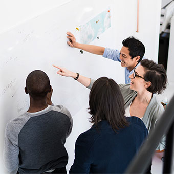 Viasat employees collaborating on a whiteboard