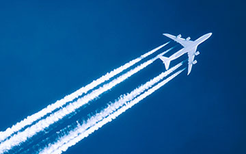 A jet connected by Viasat satellite interent flying through the sky