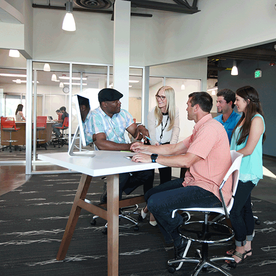 A diverse group of Viasat employees collaborating at a table