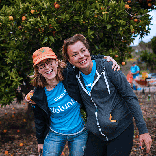 Two Viasat employees volunteering to improve their community