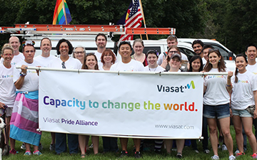 Viasat employee holding card during Pride