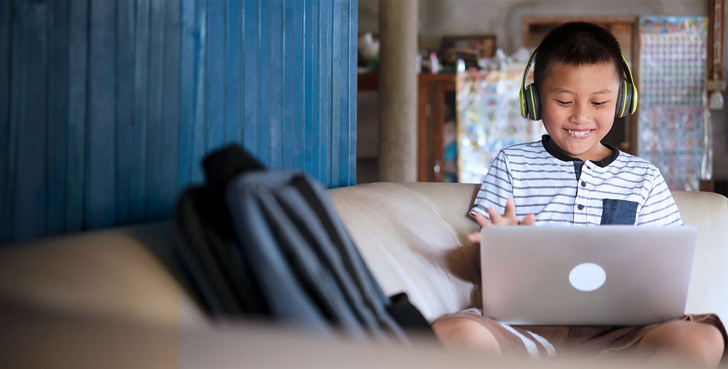 A boy on his laptop doing schoolwork using Viasat satellite internet