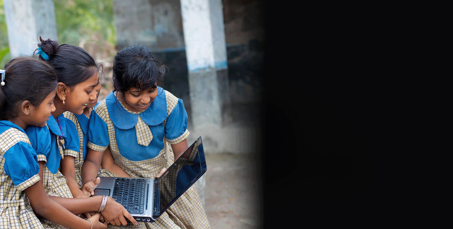 Children in a remote village using a laptop for school