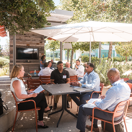 Viasat employees working at an outside conference room in Carlsbad, CA