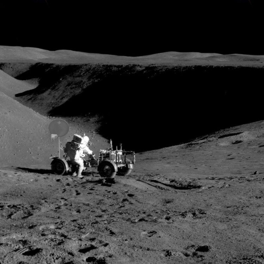 A man on the moon with a moon rover