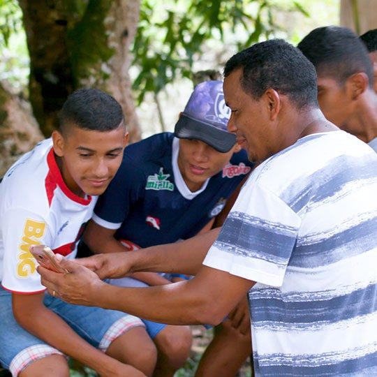 young men connecting over mobile through community wi-fi