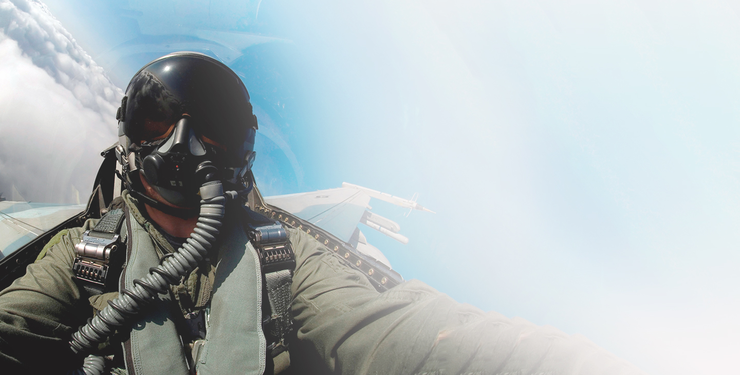 Close-up view of the front of a fighter pilot wearing flight gear in a jet