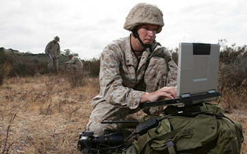 Warfighter in a field utilizing satcom on the move to communication on a laptop