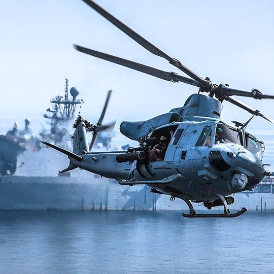UH-60 flying by an aircraft carrier out at sea