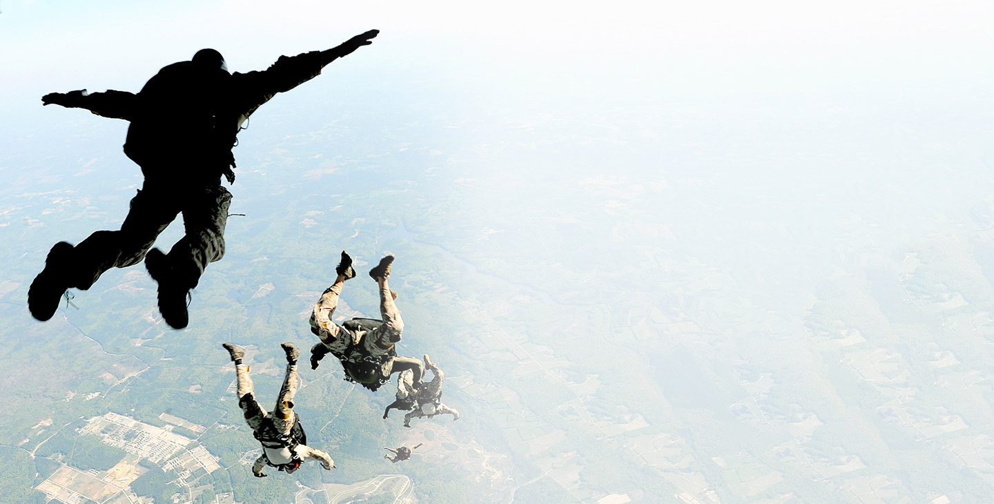 Paratroopers jumping out of an aircraft