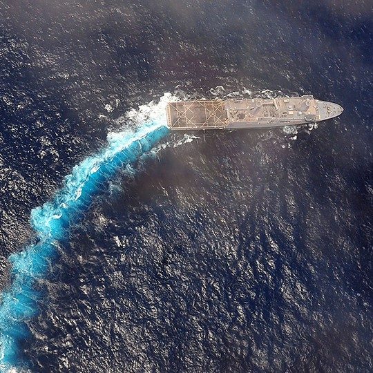 Aerial view of a military ship out at sea