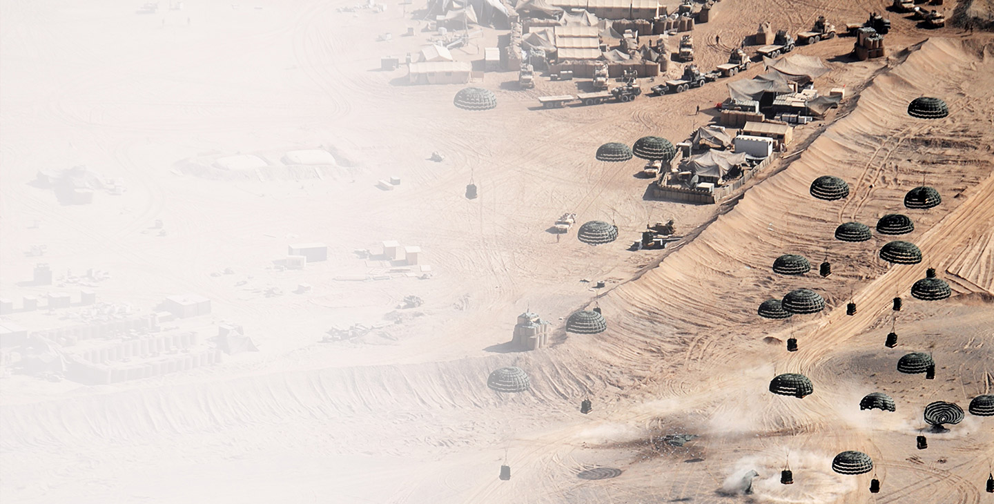 Supplies dropping from paracutes at a forward operating base in the desert