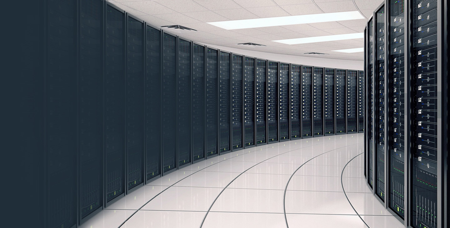 Hallway extending down a server room lined with black equipment on both sides