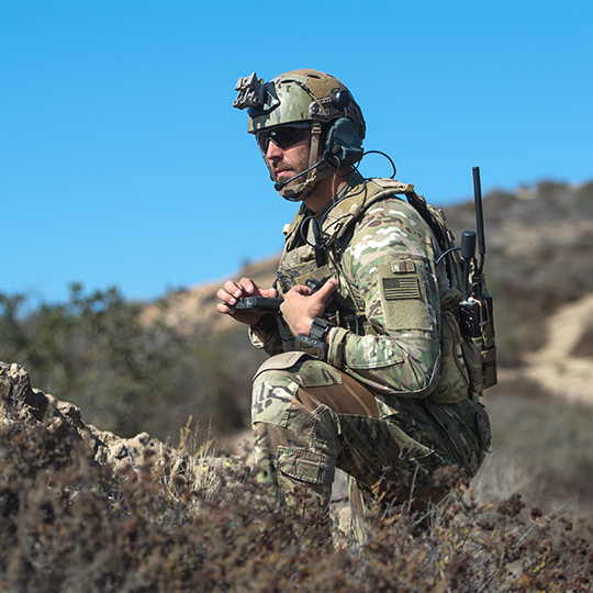 Soldier in the field holding equipment from the ELITE portable kit