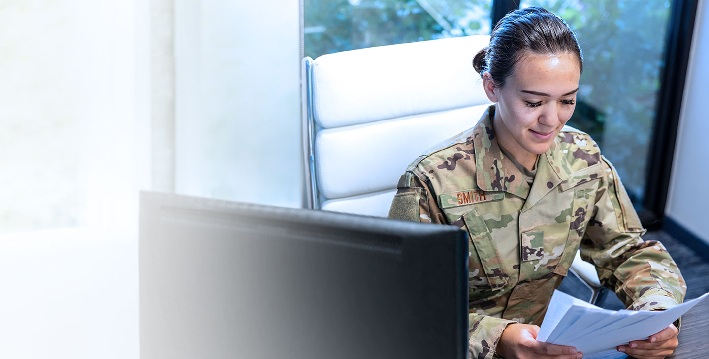 Man in an army uniform sitting at a desk using Eclypt technology to safeguard data on his laptop