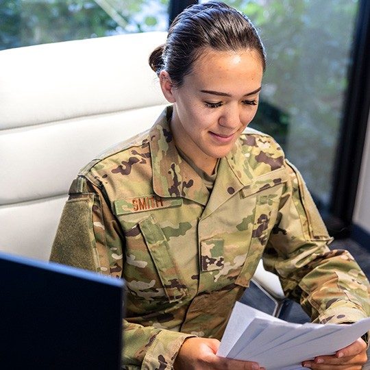 Man in an army uniform sitting at a desk using Eclypt technology to safeguard data on his laptop