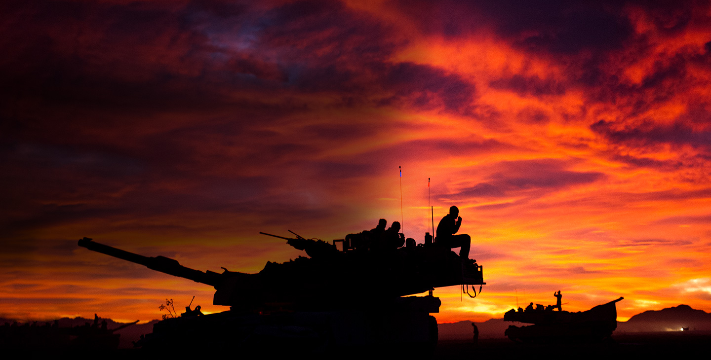 Silhouette of two tanks and soldiers
