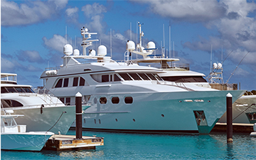 Several yachts equipped with satellite internet antennas parked at the dock