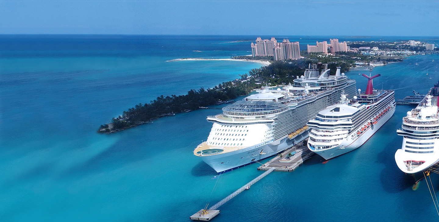 Passenger cruise ships equipped with boat internet docked near an island