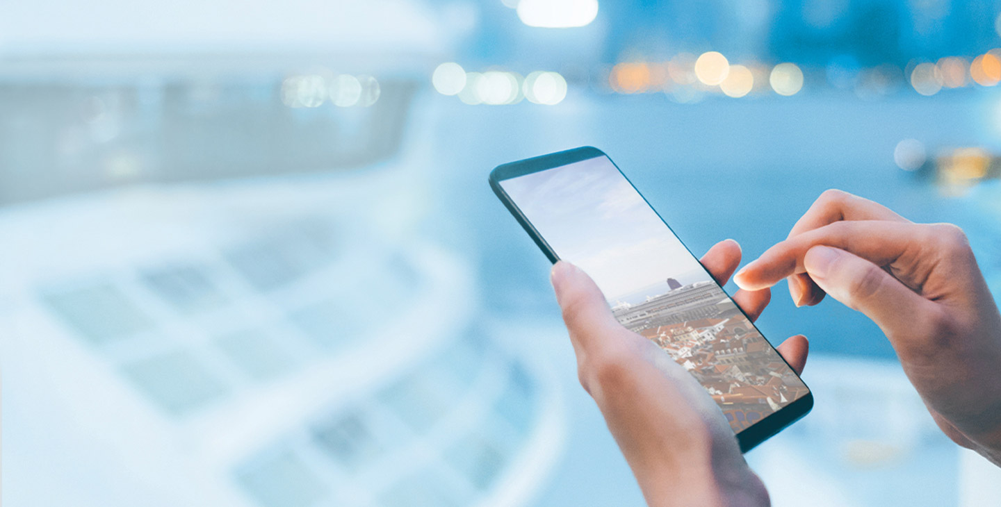 Close up of a woman's hand using a smart phone on a yacht