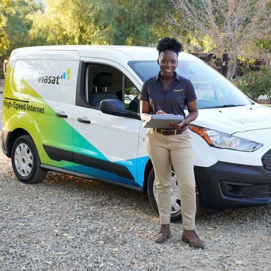 Viasat technician next to viasat van