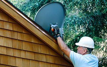 man installing Viasat internet dish