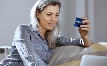 Woman holding credit card getting ready to purchase home internet
