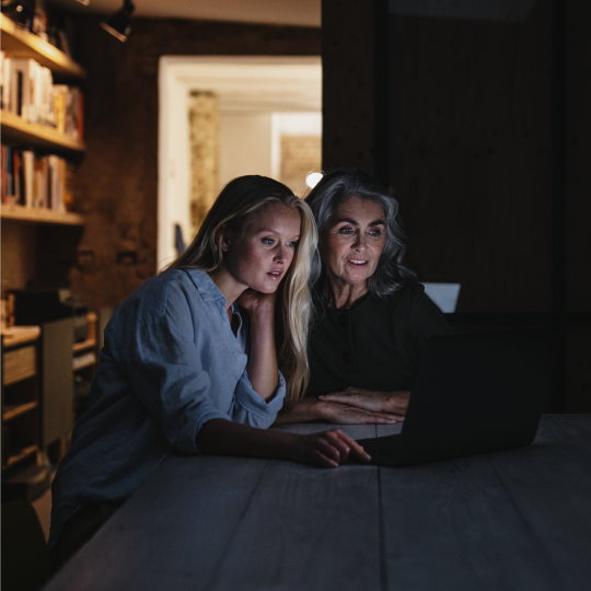two women using a laptop during a power outage
