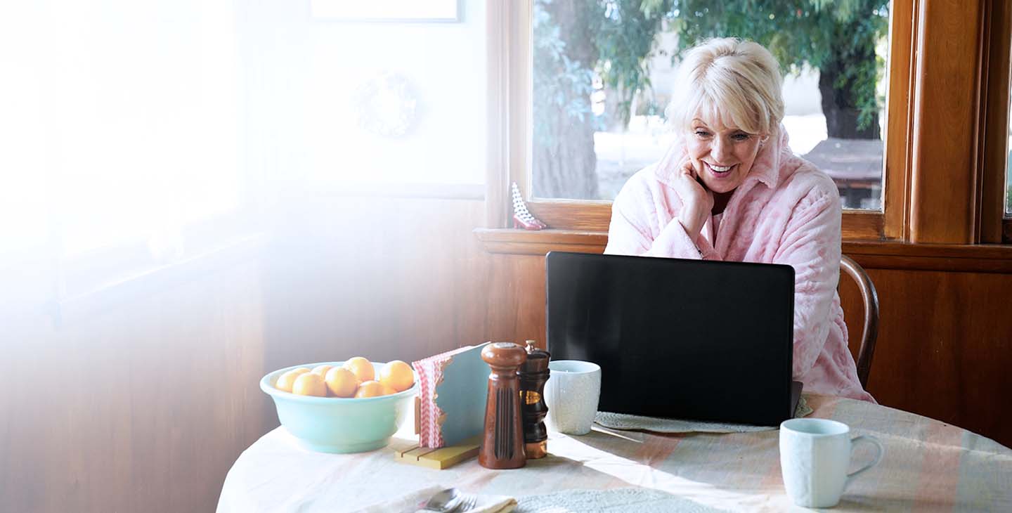 Woman enjoying connecting with her family on her laptop with Viasat satellite home internet
